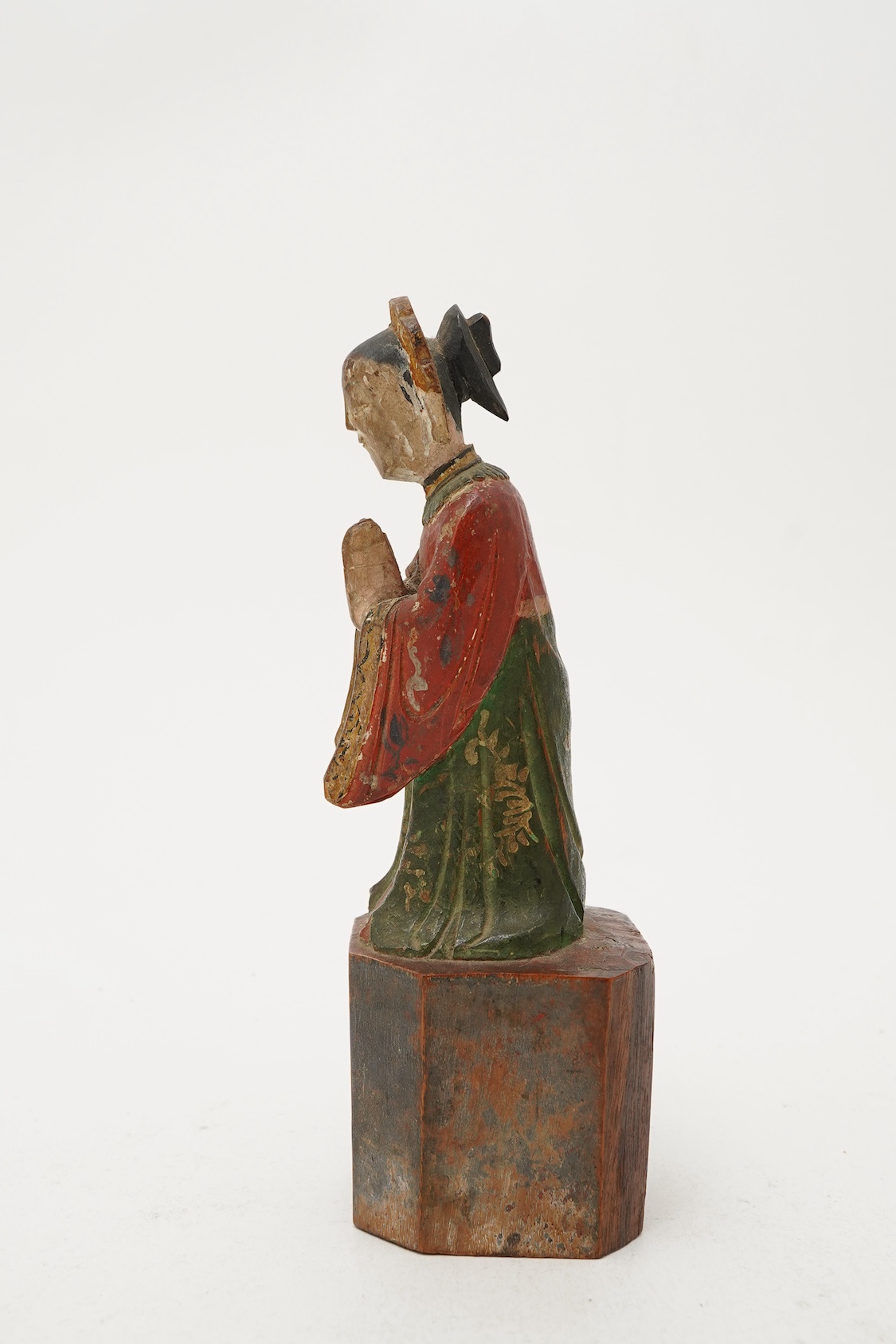 A Chinese polychrome wood figure of a female attendant, Qing dynasty